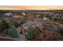 Expansive property with an updated home, lush landscaping, and sweeping sunset views at 1159 Buffalo Ridge Rd, Castle Pines, CO 80108