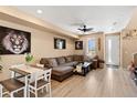 Spacious living room featuring a large sectional couch and light wood floors at 23584 E 5Th Pl, Aurora, CO 80018