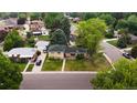 An aerial view of a well-maintained neighborhood showcasing a quaint home with lush landscaping and mature trees at 2592 S Winona Ct, Denver, CO 80219