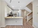 Modern kitchen featuring stainless steel appliances, granite countertops and convenient breakfast bar at 558 E Dry Creek Pl, Littleton, CO 80122
