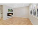 Bright living room with hardwood floors, modern fireplace and natural light from the windows at 558 E Dry Creek Pl, Littleton, CO 80122