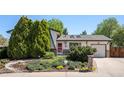 Charming home featuring a well-maintained yard with mature trees and beautiful landscaping at 11279 E Alaska Pl, Aurora, CO 80012