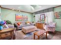 Bright living room with skylights, comfortable seating, and colorful decor at 11279 E Alaska Pl, Aurora, CO 80012
