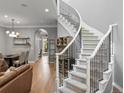Spacious living room features a staircase with metal railing, hardwood floors, and an open layout at 425 Steele St, Denver, CO 80206