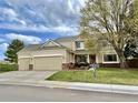 Charming two-story home with a three-car garage, inviting front porch, and well-maintained lawn at 5090 Golden Valley Trl, Castle Rock, CO 80109