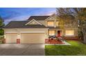 Beautiful two-story home featuring a well-maintained lawn and a spacious three-car garage at 5090 Golden Valley Trl, Castle Rock, CO 80109