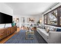 Comfortable living room with hardwood floors, stylish furniture, and a view to the hallway at 1841 S Forest St, Denver, CO 80222