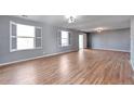 Bright living room with hardwood floors and shuttered windows at 11069 York St, Northglenn, CO 80233