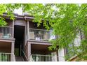 Relaxing outdoor balcony featuring comfortable seating, complemented by the surrounding natural beauty and sunlight at 830 S Vance St # F, Lakewood, CO 80226