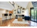 Bright living room with a soaring ceiling, hardwood floors, stylish decor, and a seamless flow to the kitchen at 830 S Vance St # F, Lakewood, CO 80226