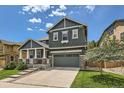 Charming two-story home boasts a well-maintained lawn and a welcoming front porch with stone accents at 10935 Valleybrook Cir, Highlands Ranch, CO 80130