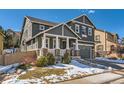 Charming two-story home with stone accents, covered porch, and attached two-car garage at 10935 Valleybrook Cir, Highlands Ranch, CO 80130