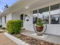 Up close image of a charming home with a decorative plant hanger by the front door at 6863 S Detroit Cir, Centennial, CO 80122