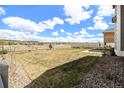 Large grassy backyard with a white fence, offering privacy and plenty of space for outdoor activities at 5736 Cadara Way, Parker, CO 80134