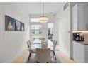 Bright dining room with glass table, modern chandelier, and view to the outdoor patio at 4062 W 16Th Ave, Denver, CO 80204