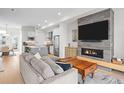 Open concept living area with fireplace, modern sofa, and view of the kitchen and dining area at 4062 W 16Th Ave, Denver, CO 80204