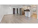 Open-concept living space with modern gray flooring, updated kitchen, and a sleek stainless steel refrigerator at 2 Adams St # 608, Denver, CO 80206