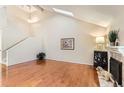 Spacious living room with hardwood floors, fireplace and vaulted ceiling at 3242 S Heather Gardens Way, Aurora, CO 80014