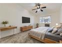 Comfortable bedroom featuring a ceiling fan, dresser and a window view at 735 S Clinton St # 5B, Denver, CO 80247
