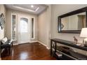 Elegant foyer with hardwood floors, a decorative mirror, and a stylish console table at 634 Hiddenbrook Ct, Highlands Ranch, CO 80126