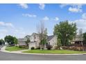 Exterior view of a charming two-story house featuring well-maintained landscaping and mature trees at 20304 Vista Cir, Parker, CO 80138