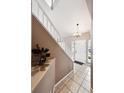 Bright foyer featuring tile floors, a staircase with white railings, and natural light at 20304 Vista Cir, Parker, CO 80138