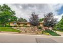 Charming brick home boasts well-maintained landscaping, rock garden, and mature trees at 9650 W 35Th Ave, Wheat Ridge, CO 80033