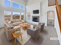 Bright living room with vaulted ceilings, fireplace, and large windows offering plenty of natural light at 23559 Branston Ln, Parker, CO 80138