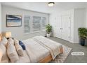 Serene main bedroom featuring ample natural light, neutral decor, and a spacious closet at 23559 Branston Ln, Parker, CO 80138