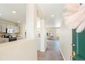 Inviting foyer with gray laminate flooring, and easy access to the kitchen and living areas at 13915 Ivanhoe St, Thornton, CO 80602