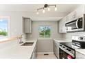 Bright kitchen featuring stainless steel appliances, light cabinets, and a window view at 13244 Quivas St, Denver, CO 80234