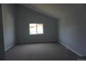 A carpeted bedroom with a large window and neutral wall paint at 8832 Lipan St, Thornton, CO 80260