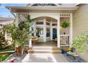 Inviting front porch with swing, seating, and decorative plants at 1089 E 131St Dr, Thornton, CO 80241