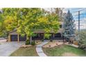 Inviting two-story home boasting a charming front yard, and a two car garage with fall foliage at 5720 E Caley Ave, Centennial, CO 80111