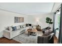 Bright living room with modern furniture, hardwood floors, area rug, and natural light at 6943 Ingalls St, Arvada, CO 80003