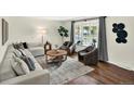 Cozy living room with hardwood floors, modern furniture, an area rug, and a large window at 6943 Ingalls St, Arvada, CO 80003