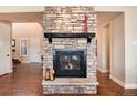 Cozy fireplace with stone surround and mantel at 10751 Manorstone Dr, Highlands Ranch, CO 80126