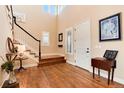 Bright foyer with wood floors, staircase, and natural light at 10751 Manorstone Dr, Highlands Ranch, CO 80126