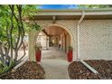 Arched brick entrance with double doors and decorative plants at 11496 E Wesley Ave, Aurora, CO 80014