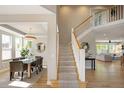 Open foyer with staircase leading to the upper level and views of the dining and living areas at 1996 Clipper Dr, Lafayette, CO 80026