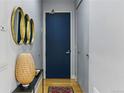 Stylish entryway with hardwood floors, golden mirrors, decorative vase, and blue accent door at 1738 N Franklin St # 2B, Denver, CO 80218