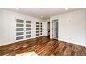 Spacious bedroom with wood floors, white walls, and closet doors with translucent glass panels at 21743 Farmingdale Ct, Parker, CO 80138