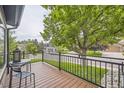 Inviting balcony with wood floors, metal railings, seating and neighborhood views at 8657 Aberdeen Cir, Highlands Ranch, CO 80130