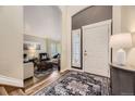 Inviting entryway with hardwood floors, a decorative rug, and views into the living room at 8657 Aberdeen Cir, Highlands Ranch, CO 80130