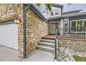 Charming home featuring stone accents, three-car garage, and inviting front entrance at 8657 Aberdeen Cir, Highlands Ranch, CO 80130
