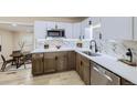 Updated kitchen with stainless steel appliances, quartz counters, stylish tile backsplash and light wood floors at 1880 E 81St Pl, Denver, CO 80229