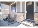Inviting front porch with stone accents and seating area for relaxing outdoors at 760 N Allium St, Watkins, CO 80137