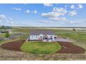 A lovely home with outdoor patio, green lawn, and professional landscaping surrounded by a fence at 527 Antelope E Dr, Bennett, CO 80102