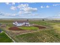 Home with a patio and a lush green lawn inside a fenced perimeter surrounded by an expansive landscape at 527 Antelope E Dr, Bennett, CO 80102