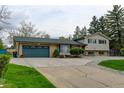 Charming home featuring an attached two-car garage, and mature trees surrounding the property at 11310 W Center Ave, Lakewood, CO 80226